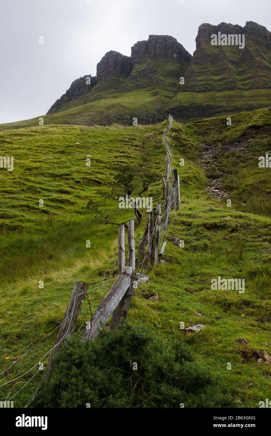 Old fence running up Mount Benbulben in the County Sligo, Ireland, on a cloudy day Stock Photo