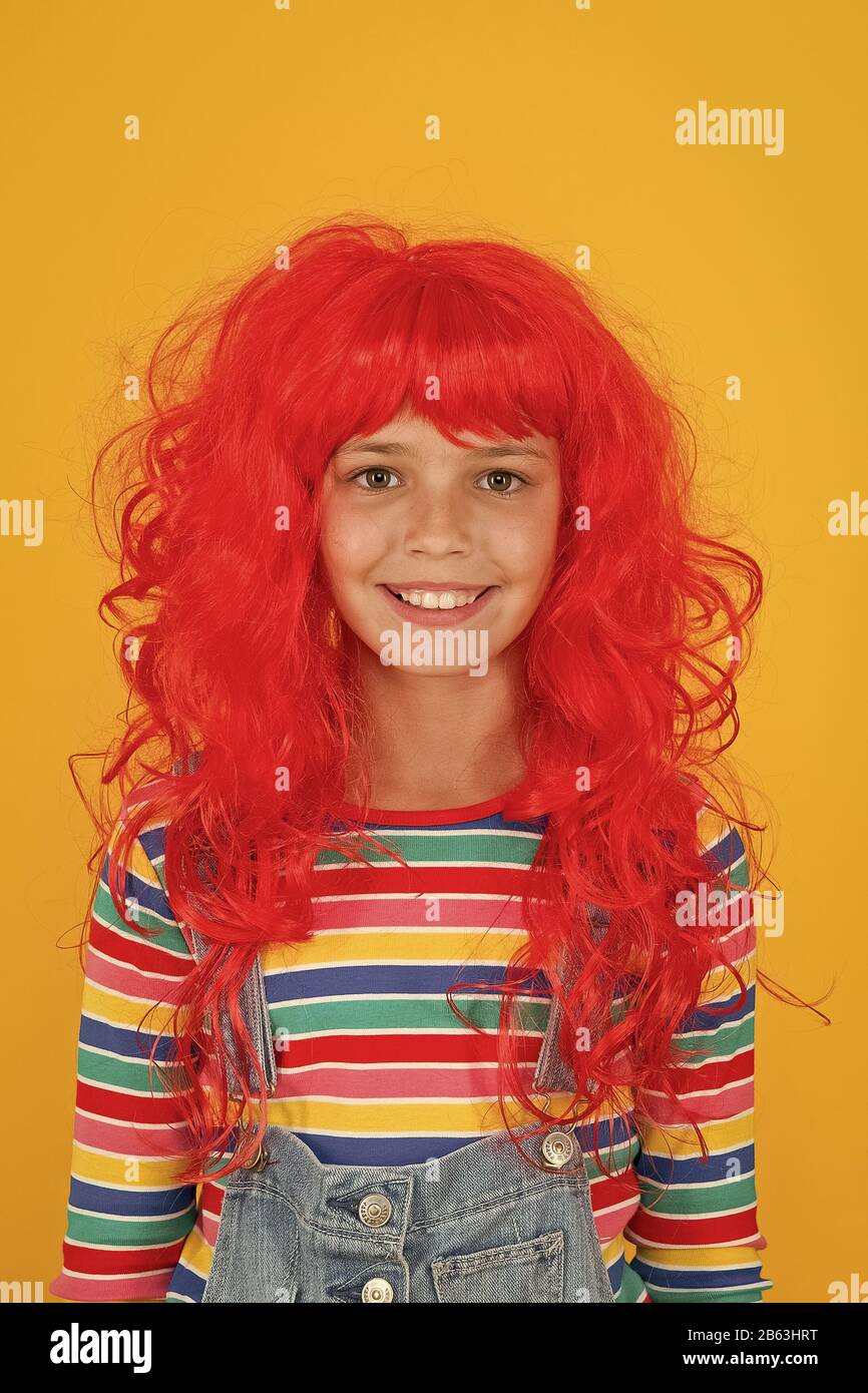 Crazy redhead wig. Messy hairstyle. Kid cheerful smiling happy redhead girl. I am ginger and proud of it. Redhead stereotypes. Redheads are not some creatures with magical soul sucking powers. Stock Photo