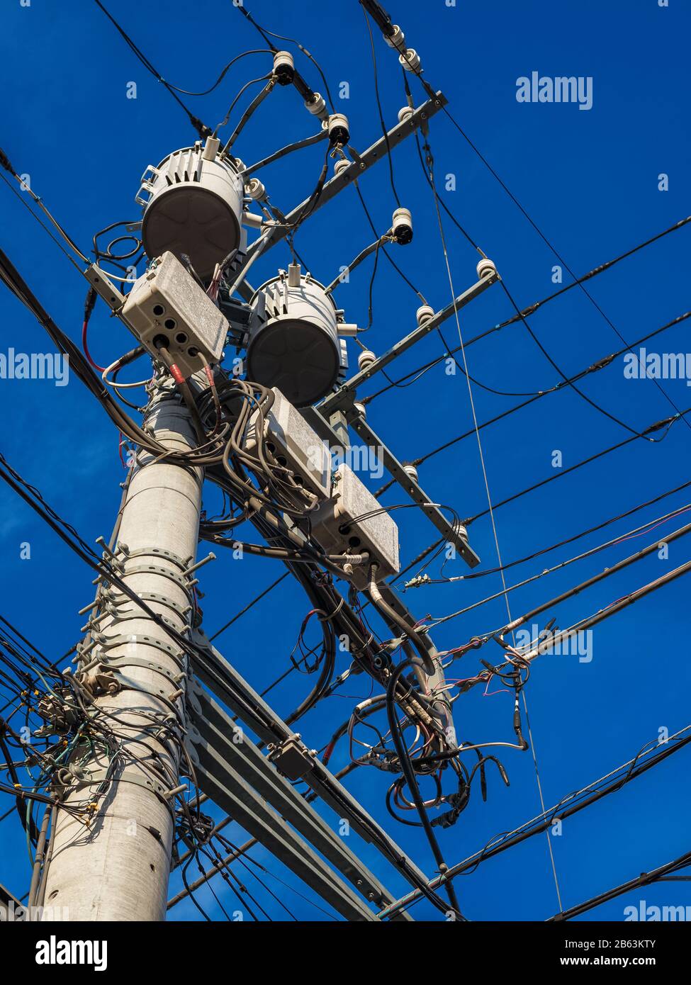 Electric power industry. Characteristic utility and transmission pole and overhead power lines in Japan Stock Photo