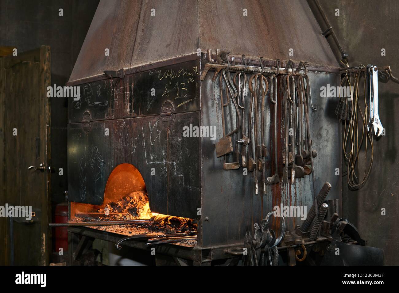 forge furnace with burning flame and blacksmith tools Stock Photo - Alamy