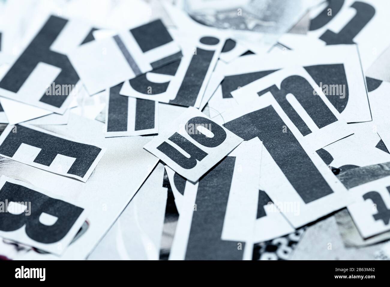 Creative backgroun made of newspaper cutout fonts scattered on table top Stock Photo