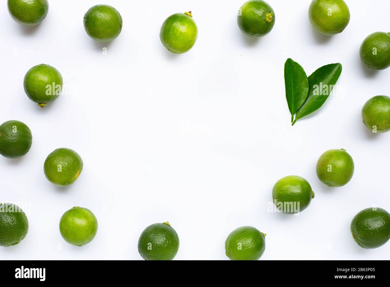 Frame made of limes with leaves isolated on white background Stock
