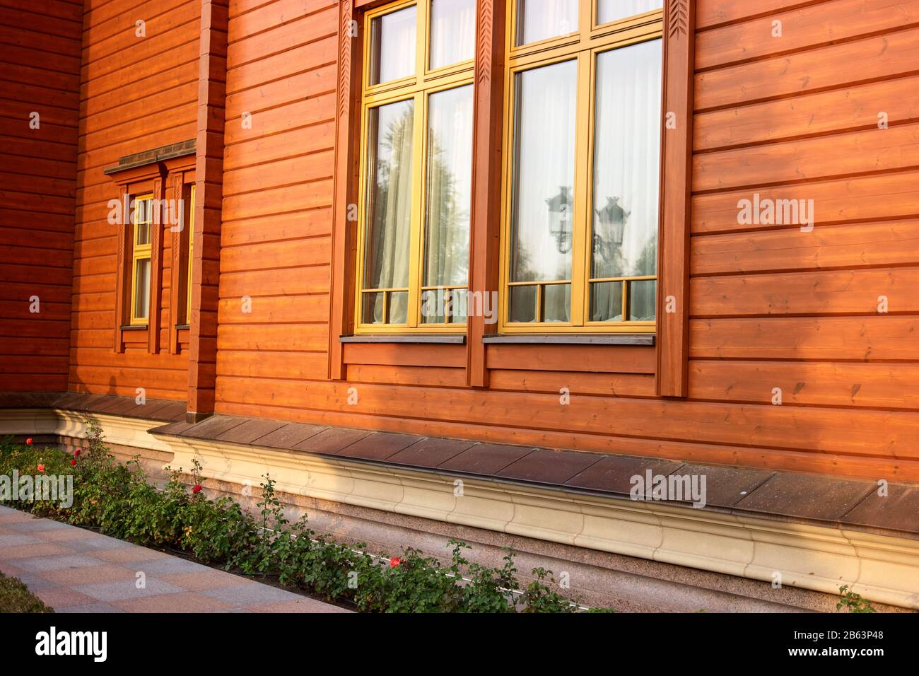 Orange wood house facade with flowers Stock Photo Alamy