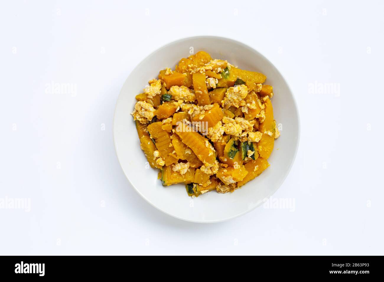 Stir-fried pumpkin with eggs on white background. Stock Photo