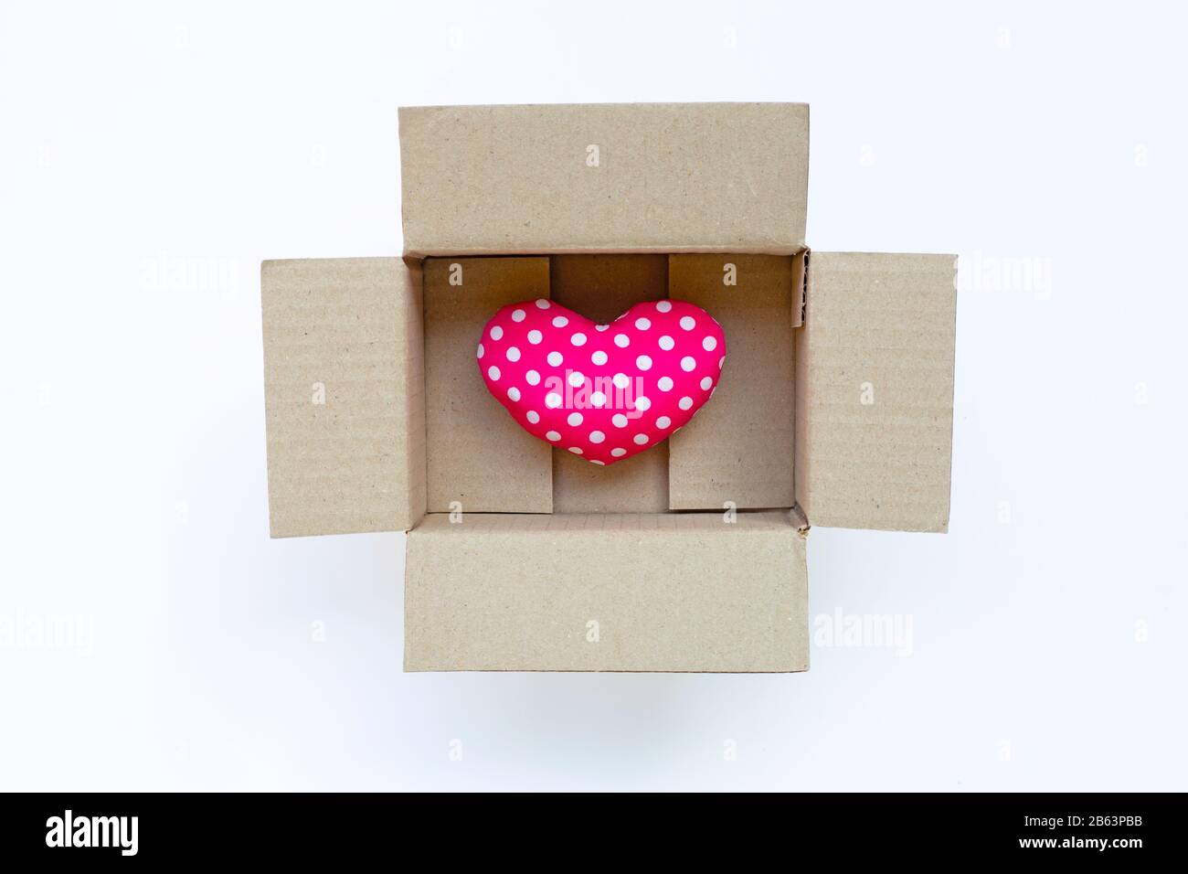 Pink heart in opened box on white background. Stock Photo