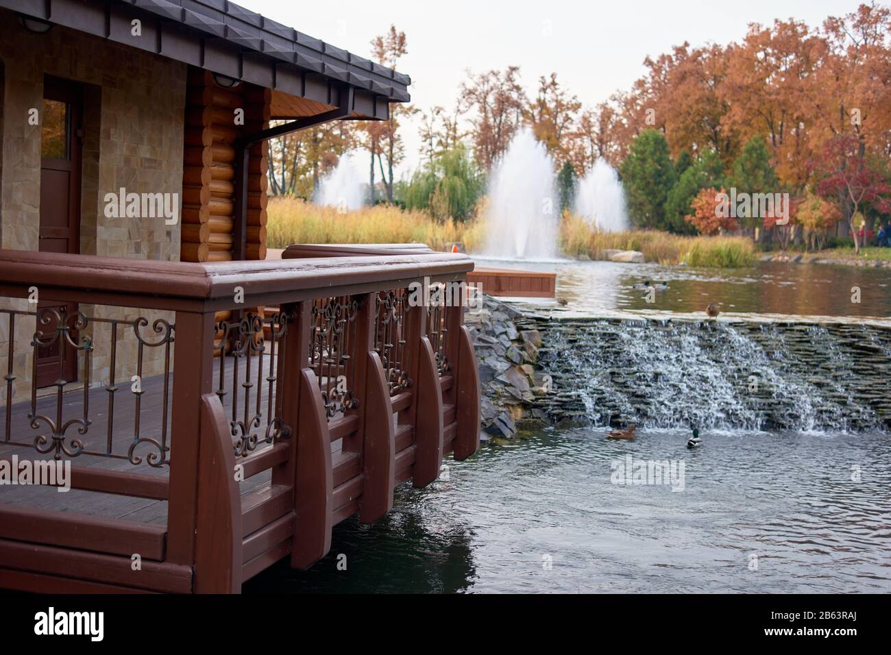 Wooden balcony upon a pond water. Stock Photo