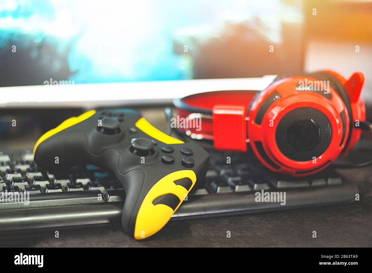 Game pad joystick and Headphones on keyboard playing gaming and watching video on tv or Computer games console concept Stock Photo