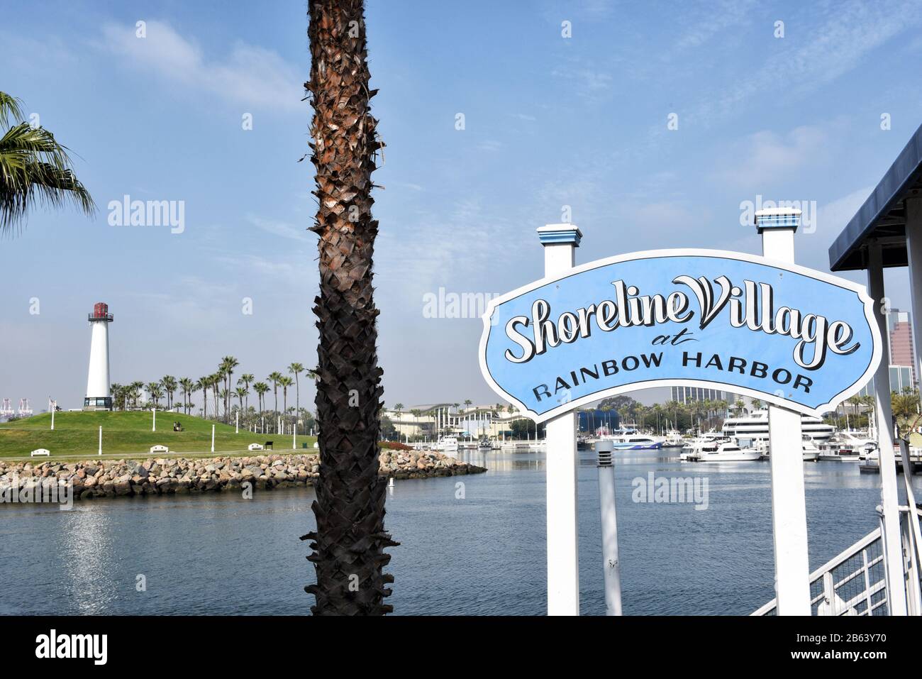 LONG BEACH, CALIFORNIA - 06 MAR 2020: Shoreline Village sign at Rainbow Harbor with Lighthouse in the distance. Stock Photo