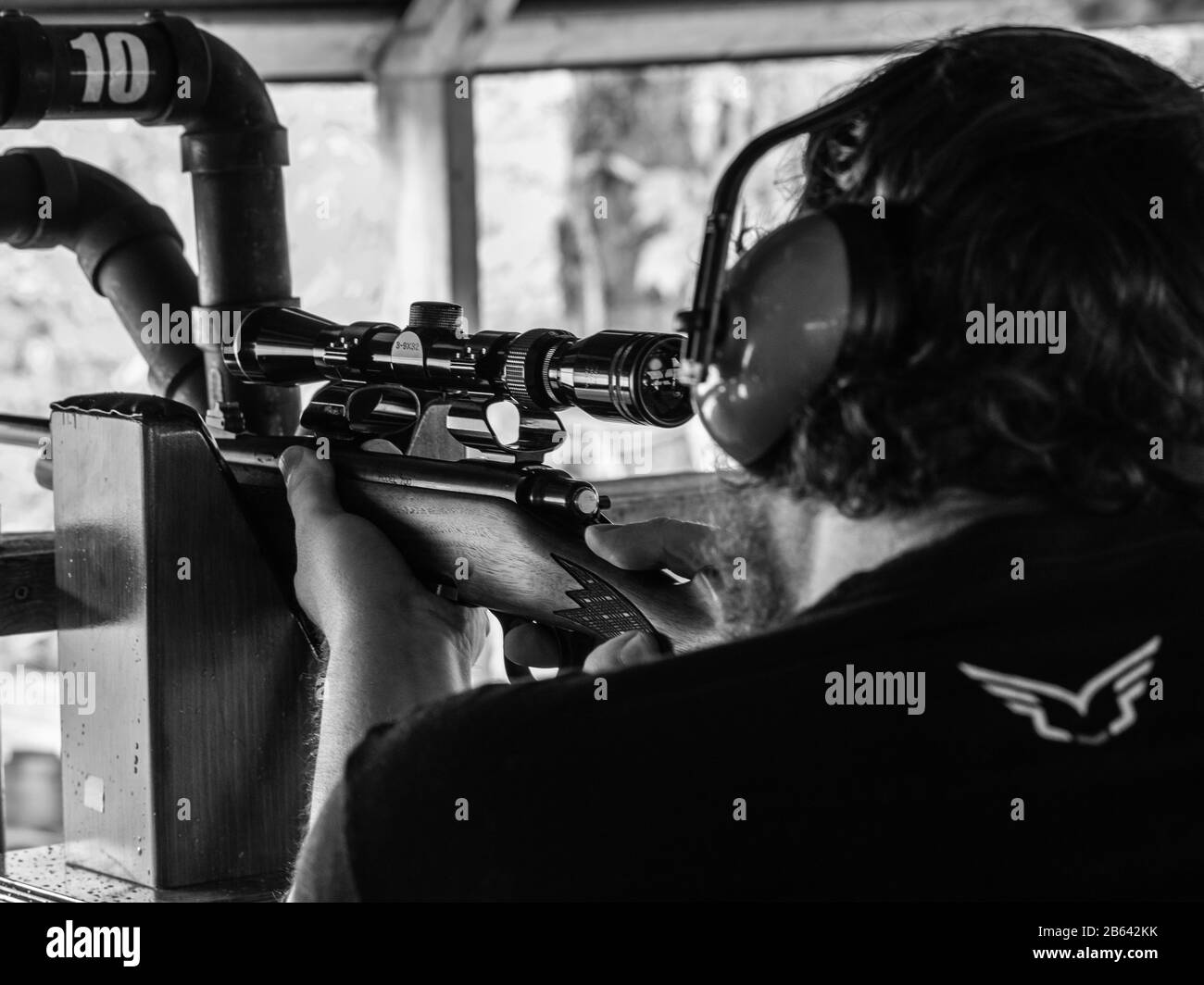 Man Shooting 30.06 rifle at shooting range Stock Photo