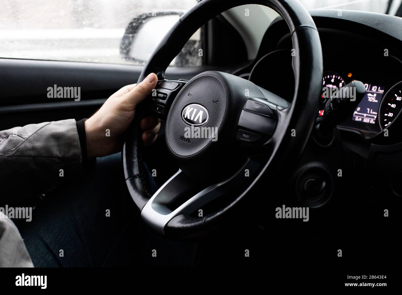 Moscow, Russia - January 2, 2020: Black steering wheel with the KIA logo close-up. The interior of a South Korean SUV KIA Rio X-Line car. Male hand on Stock Photo