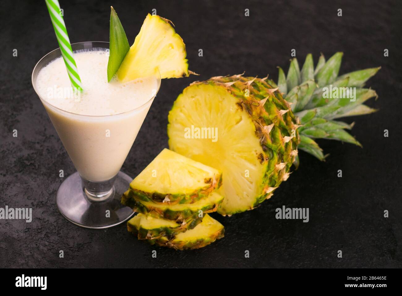 Milkshake with pineapple on a black background. Stock Photo