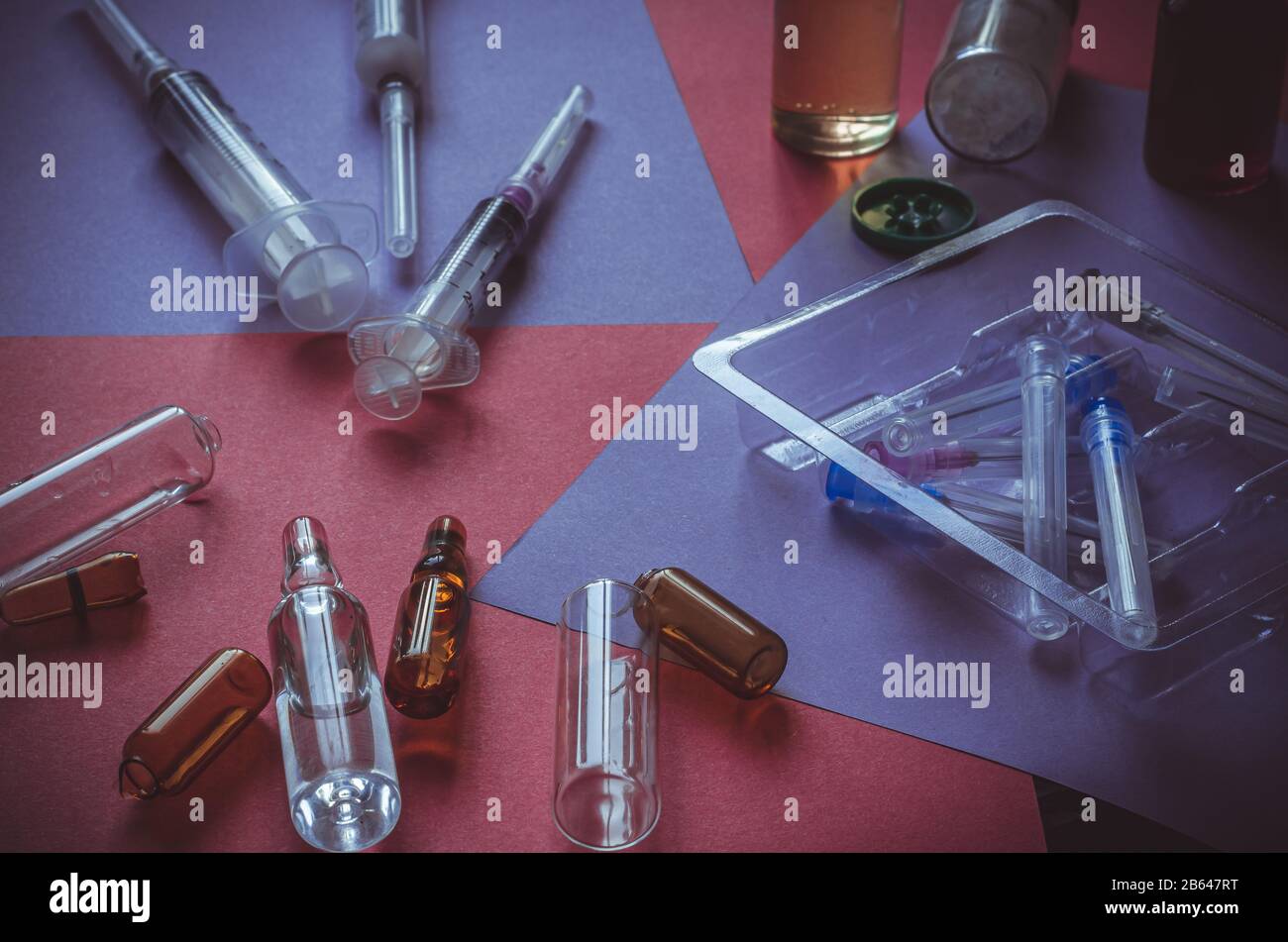 Medicines, syringes, ampoules on the table. Medications randomly scattered across the table. Hard work of doctors. Close-up. Selective focus. Without Stock Photo