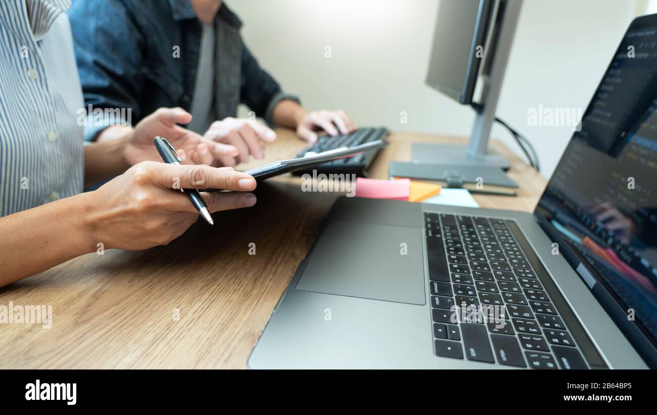 Collaborative work Software engineers website developer technologies or programmer working coding on startup ai application project on screen with par Stock Photo
