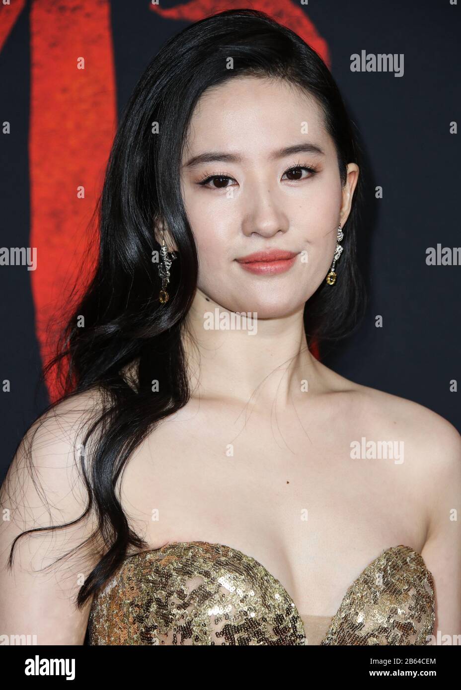 Hollywood, United States. 09th Mar, 2020. HOLLYWOOD, LOS ANGELES, CALIFORNIA, USA - MARCH 09: Actress Yifei Liu wearing a shimmering gold, strapless gown embroidered with golden silk threads and sequins, accentuated by a grandeur train from the Elie Saab Fall/Winter 2019 Haute Couture Collection and Chaumet jewelry arrives at the World Premiere Of Disney's 'Mulan' held at the El Capitan Theatre and Dolby Theatre on March 9, 2020 in Hollywood, Los Angeles, California, United States. (Photo by Xavier Collin/Image Press Agency) Credit: Image Press Agency/Alamy Live News Stock Photo