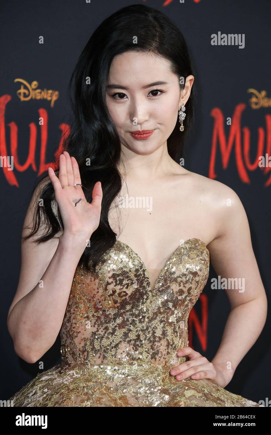 Hollywood, United States. 09th Mar, 2020. HOLLYWOOD, LOS ANGELES, CALIFORNIA, USA - MARCH 09: Actress Yifei Liu wearing a shimmering gold, strapless gown embroidered with golden silk threads and sequins, accentuated by a grandeur train from the Elie Saab Fall/Winter 2019 Haute Couture Collection and Chaumet jewelry arrives at the World Premiere Of Disney's 'Mulan' held at the El Capitan Theatre and Dolby Theatre on March 9, 2020 in Hollywood, Los Angeles, California, United States. (Photo by Xavier Collin/Image Press Agency) Credit: Image Press Agency/Alamy Live News Stock Photo