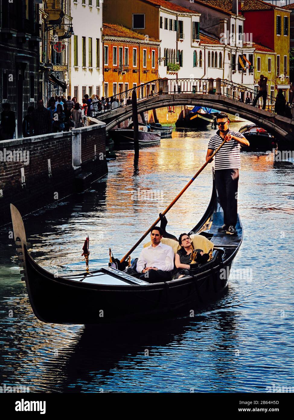 Couple sharing a romantic gondola cruise evening in Venice. Italy Stock Photo
