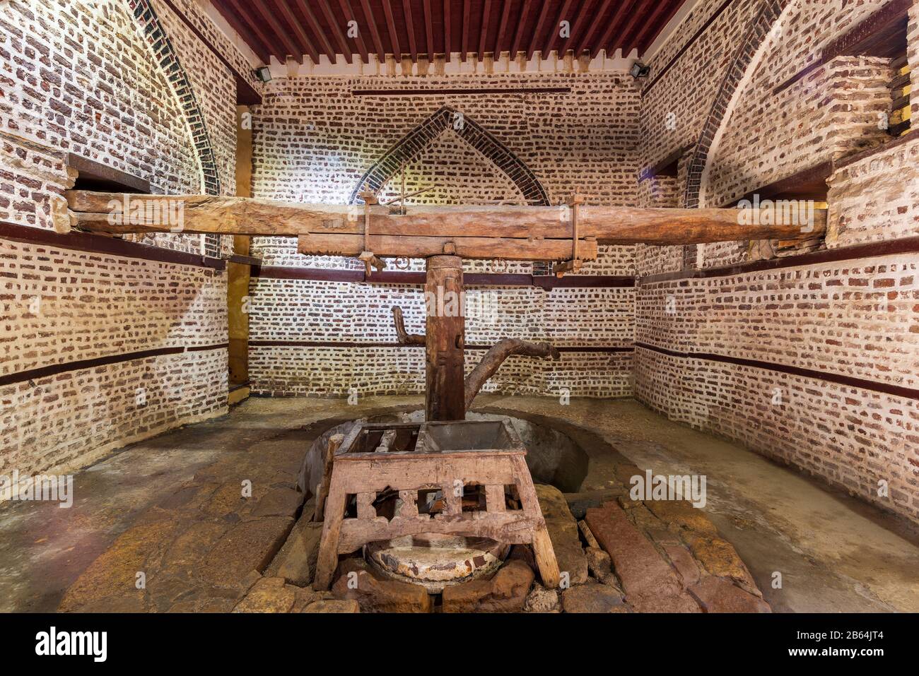 Front view of ancient rotary Flour Mill used to be rotated by animal power, known as Abu Shaheen Mill with black and red bricks wall, located next to El Amasely historic house, Rosetta city, Egypt Stock Photo