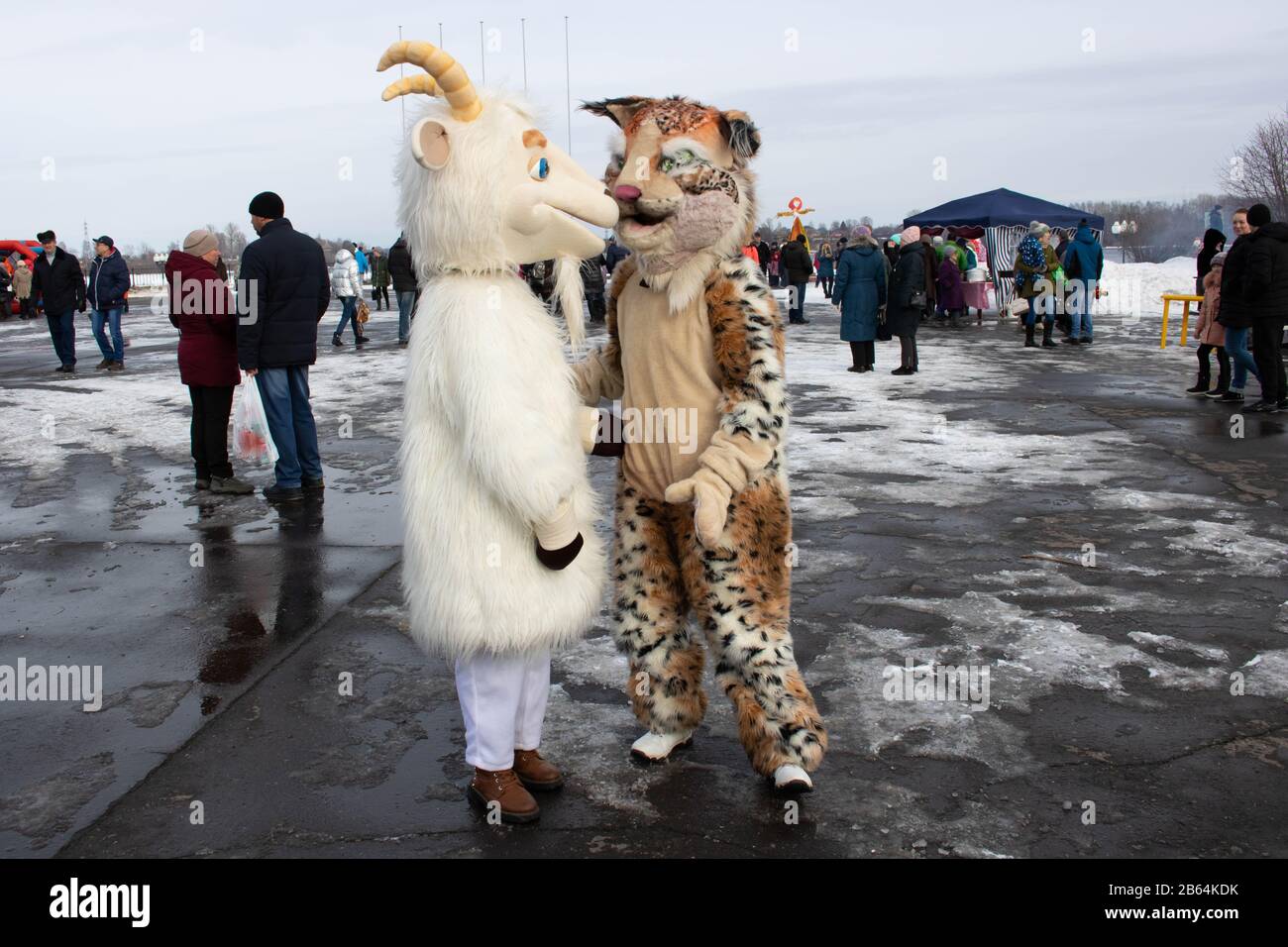 Russia. Rybinsk 1. march. 2020. National holidays and customs. A stuffed goat in the foreground. Masked mummers in the background. seeing off the Stock Photo