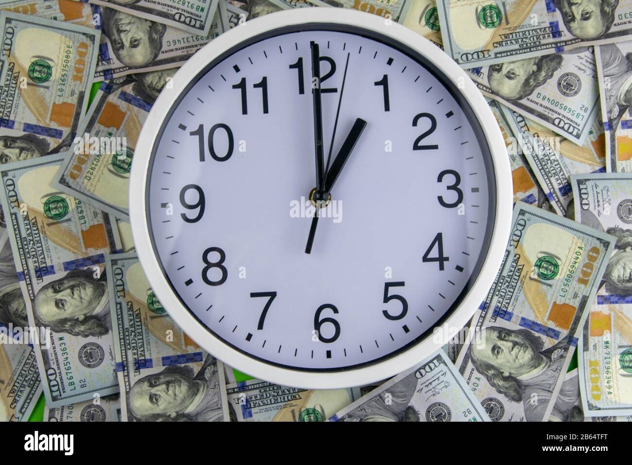 Clock and assorted American banknotes. Time is money idea Stock Photo ...