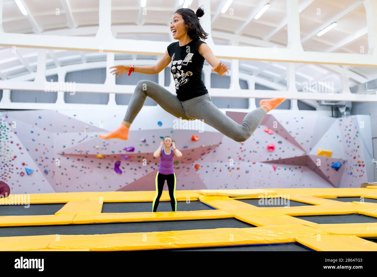 Happy brunette jumping on trampoline Stock Photo