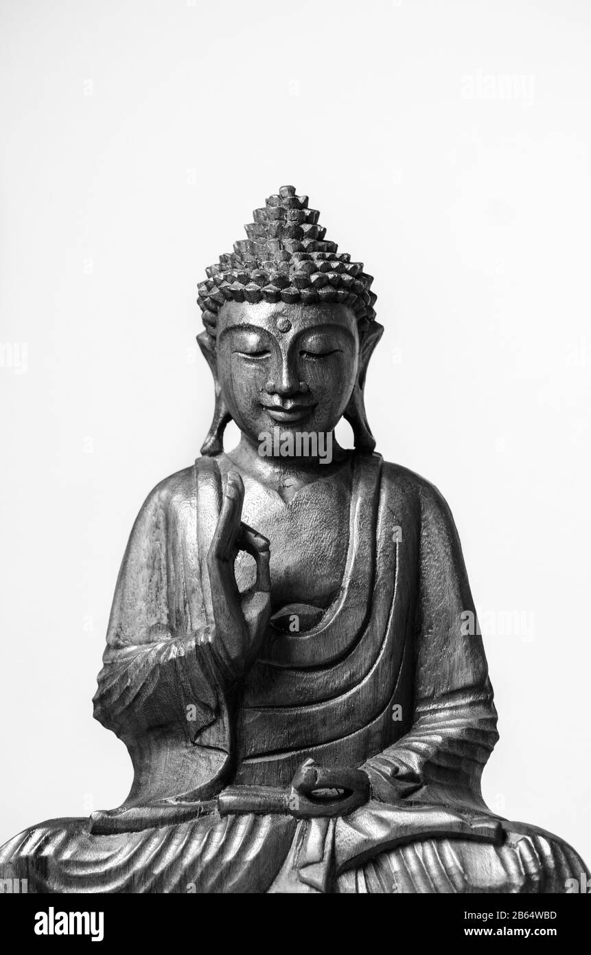 Wooden siddharha gautama buddha statue figure against clean background