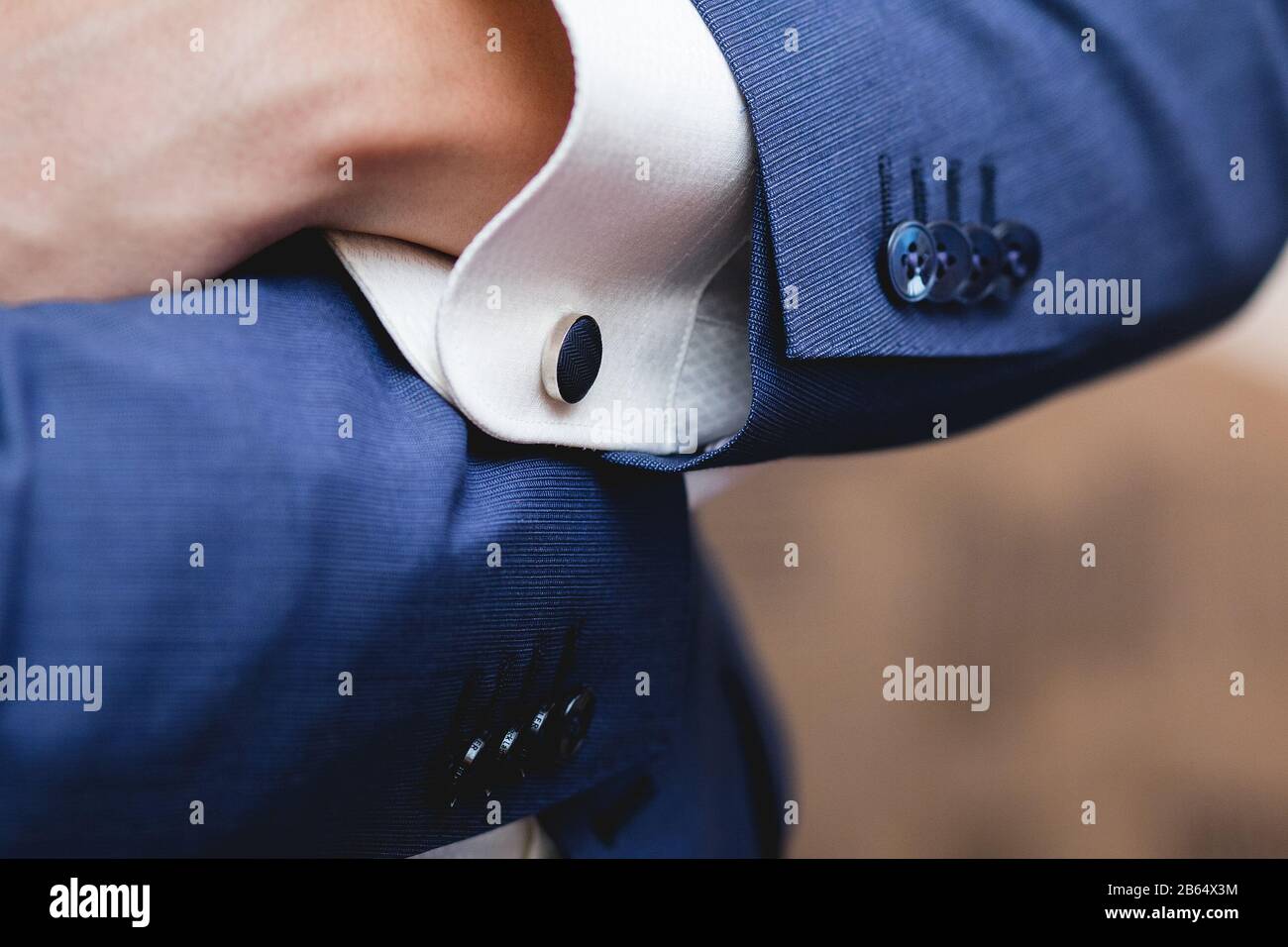 a man in a blue suit stud buttons Stock Photo Alamy