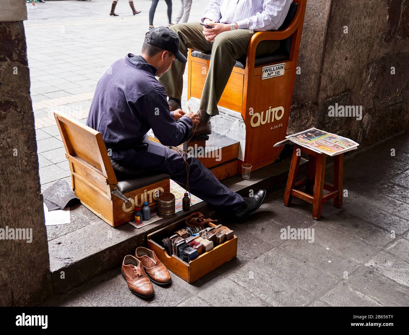 Shoe shine boy in Plaza de la Independencia Quito, Ecuador Stock Photo