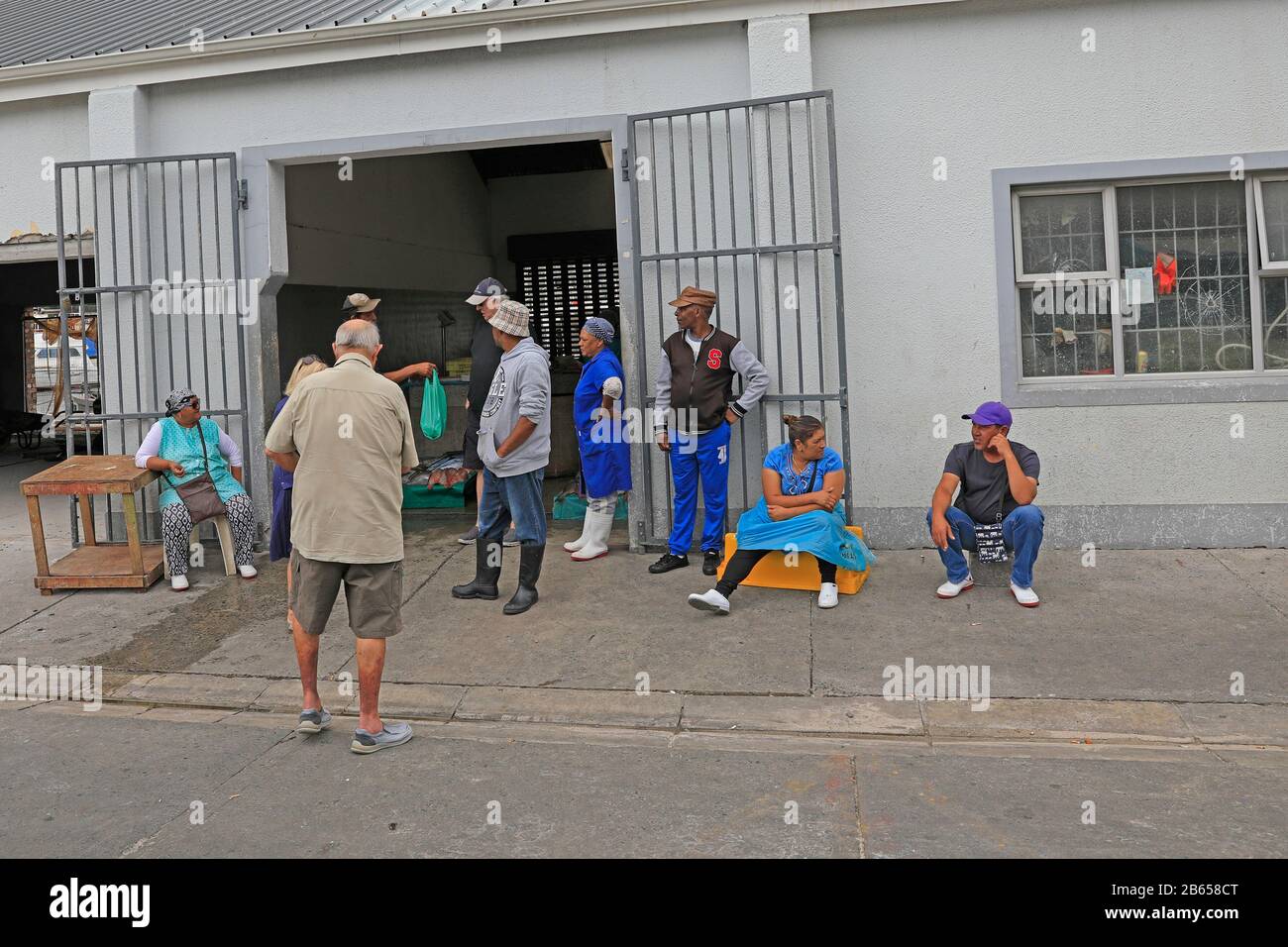 Customers buying fresh fish from Hout Bay harbour near Cape Town, South