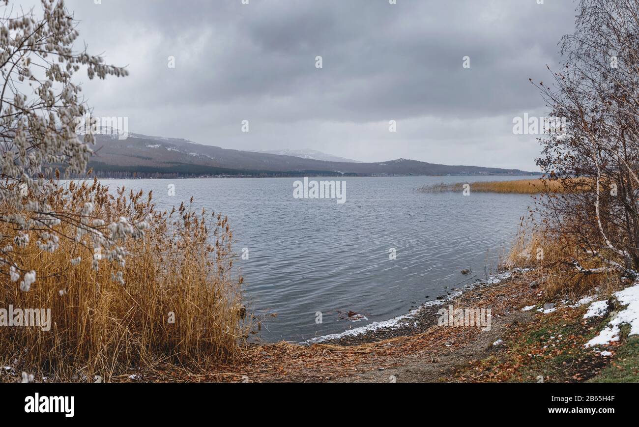 Talkas lake and early autumn snow, Ural mountains, Russia Stock Photo