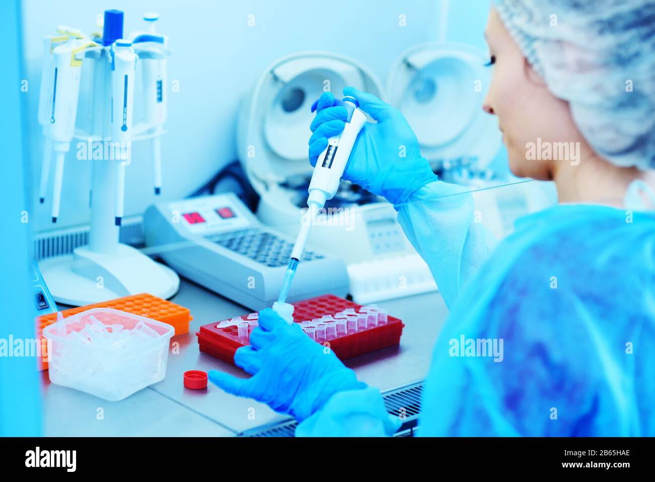 female scientist makes PCR DNA tests in a modern chemical and