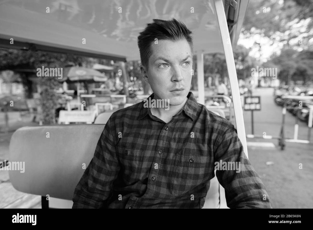 Young handsome tourist man thinking inside the cart Stock Photo