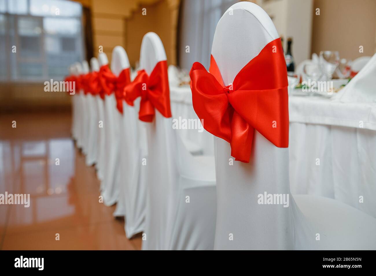 White wedding chairs with the red bows Stock Photo Alamy