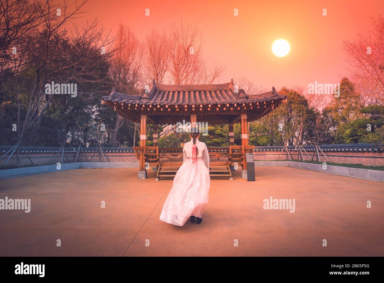 Asian korean Girls dressed Hanbok in traditional dress at sunset in South Korea. Stock Photo