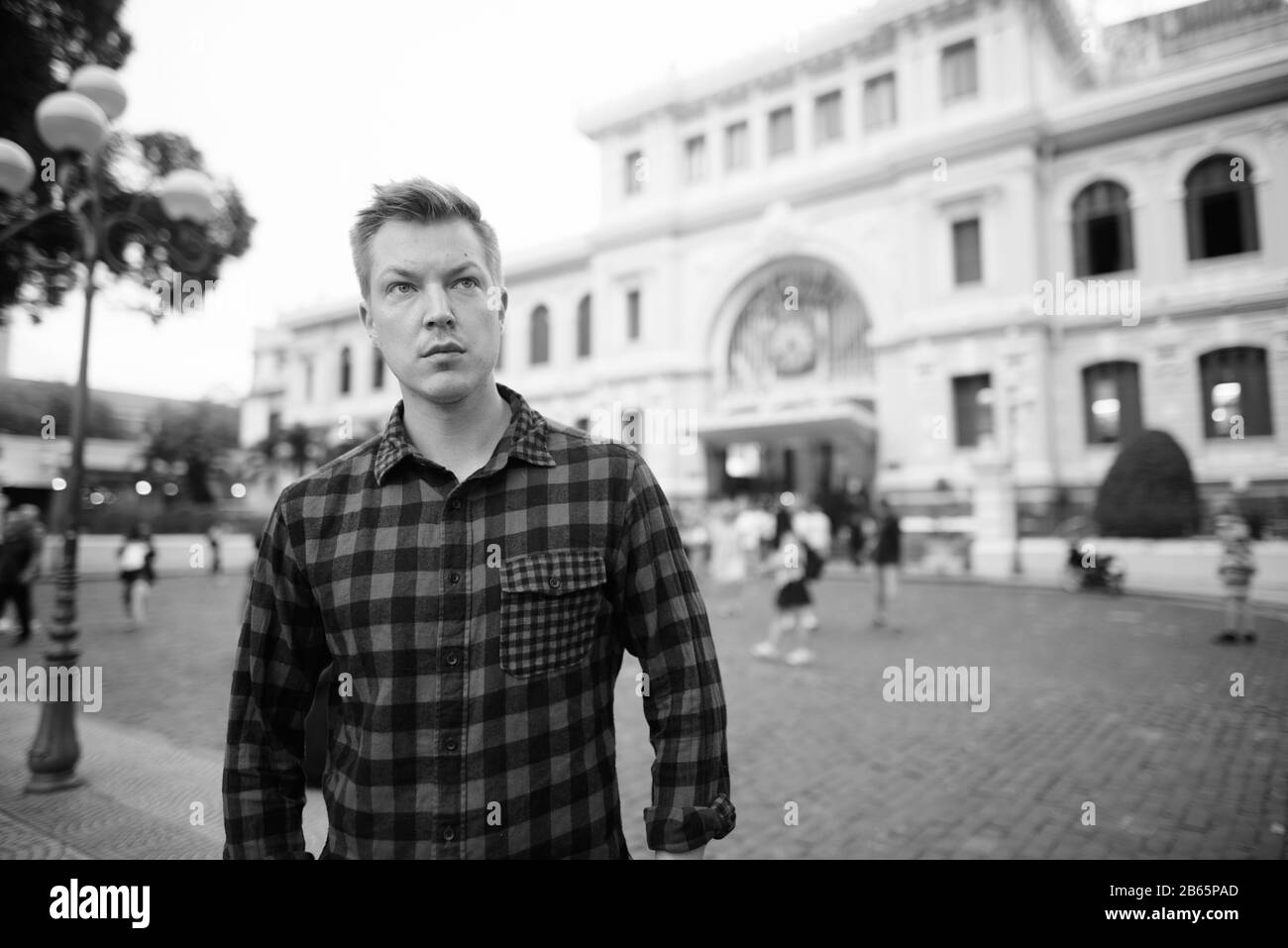 Young handsome tourist man thinking against historical building Stock Photo