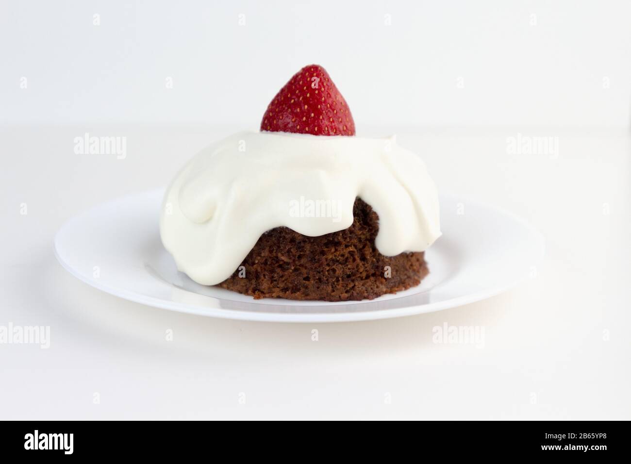Ketogenic chocolate almond cake with whipped cream and strawberry. Low