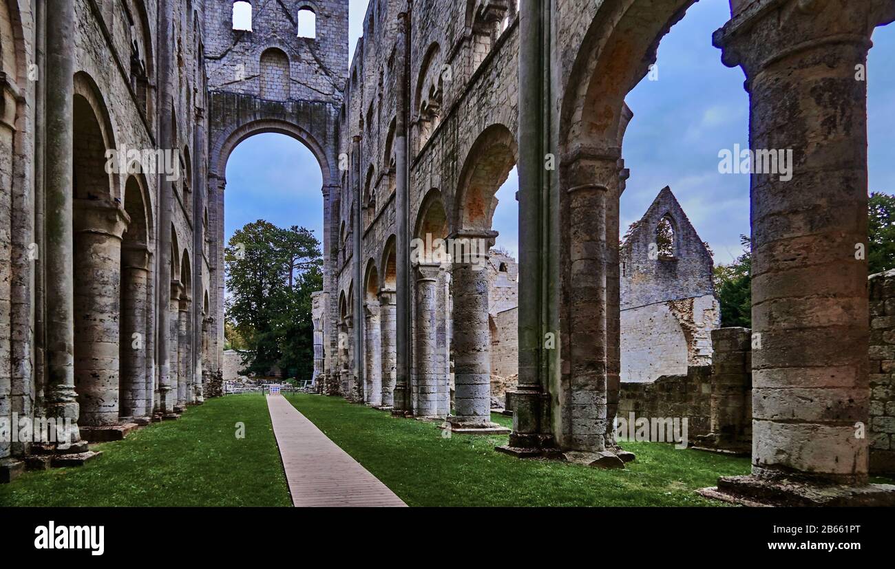 The ruins of Jumièges Abbey were a Benedictine monastery, located in the town of Jumièges, in Normandy, France.In 654,the abbey was founded on a gift of forested land belonging to the royal fisc presented by Clovis II and his queen, Balthild, to the Frankish nobleman Filibertus, who had been the companion of Saints Ouen and Wandrille at the Merovingian court of Dagobert I. Philibert became the first abbot Stock Photo