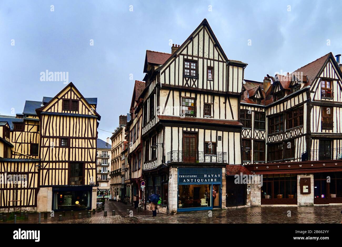 Small Medieval Streets of Rouen, France on a cloudy spring day. The city is the capital of the Normandy region of France and known for its half-timbered buildings. Stock Photo