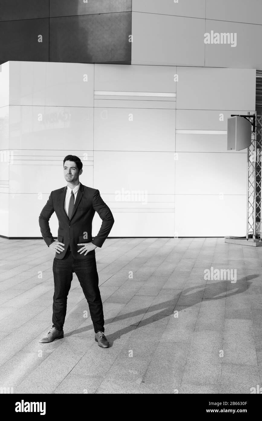 Portrait of young handsome businessman outside the building Stock Photo ...