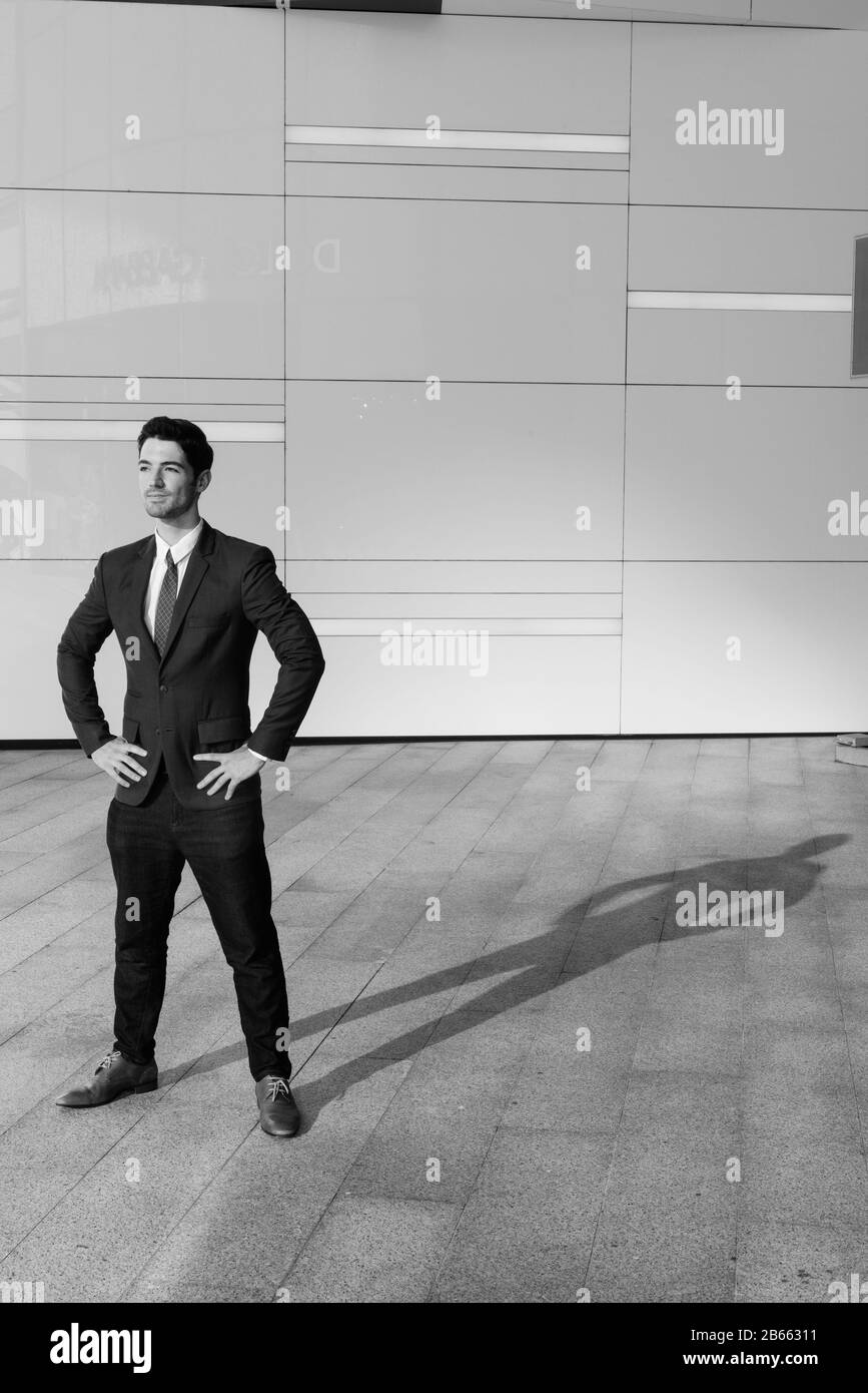 Portrait of young handsome businessman outside the building Stock Photo ...