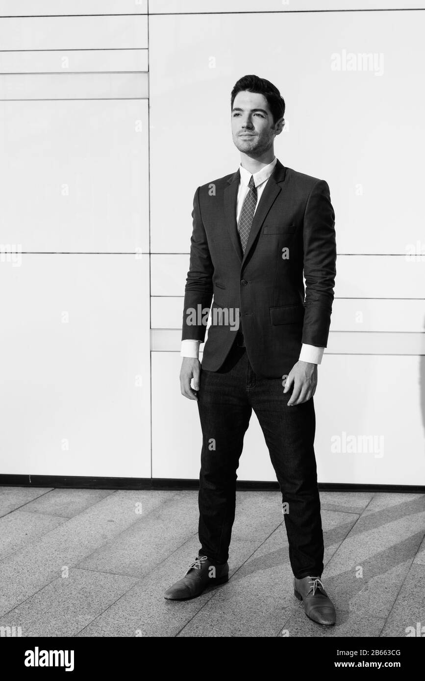 Portrait of young handsome businessman outside the building Stock Photo ...