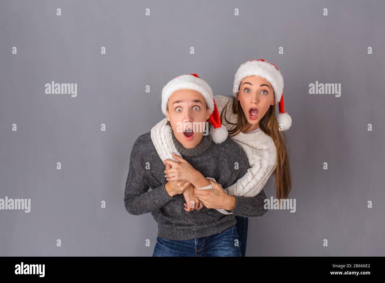 Young couple studio isolated on grey wall concept Stock Photo