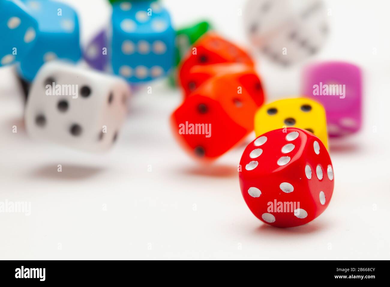 Playing dice at white wooden background. Playing a game with dice