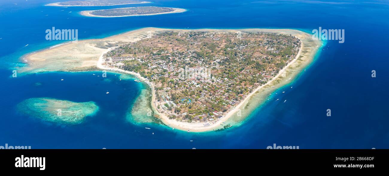 Panoramic aerial view of a beautiful tropical island surrounded by coral reef (Gili Air, Indonesia) Stock Photo