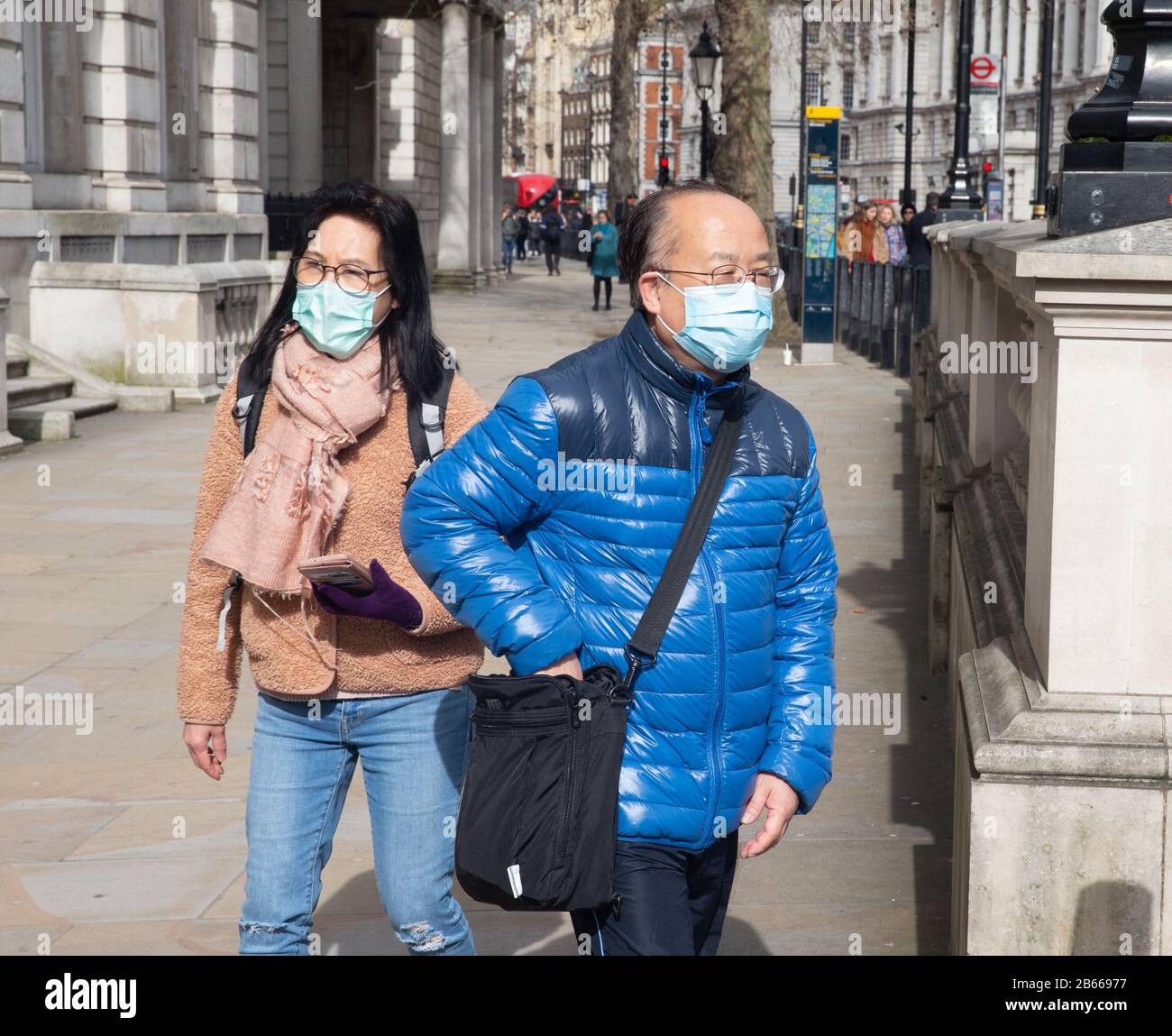 Tourists wearing masks in Whitehall, London. There is a great fear of