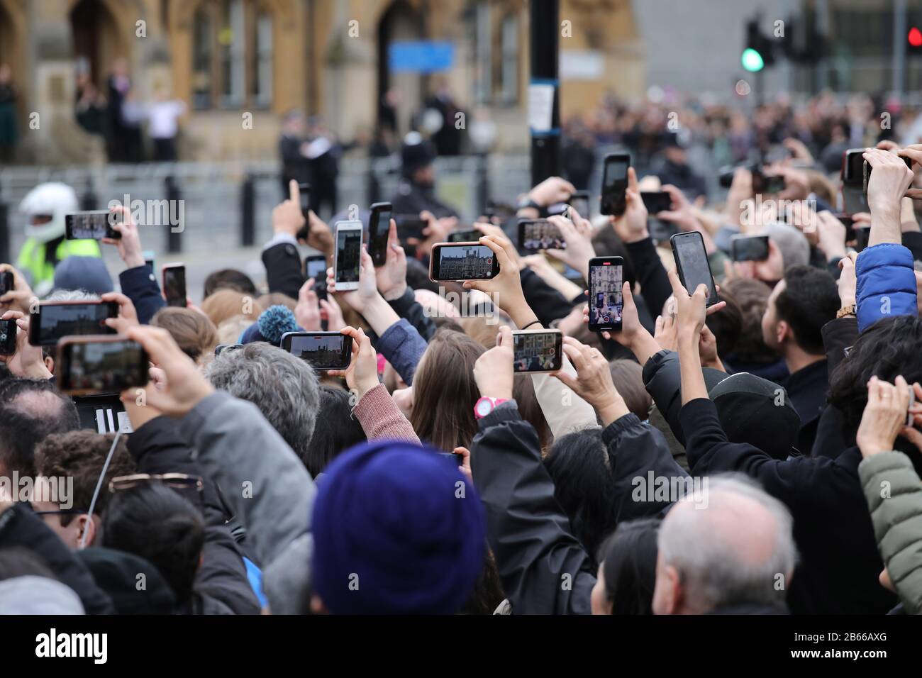 People hold up their mobile phones to try and get pictures of the Royal  family. The Commonwealth Service at Westminster Abbey today, attended by  Queen Elizabeth II, Prince Charles The Prince of