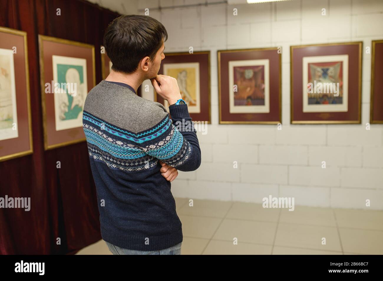 Young Caucasian People In An Art Gallery Looking At Paintings And Talking  About Them Stock Photo, Picture and Royalty Free Image. Image 22573792.