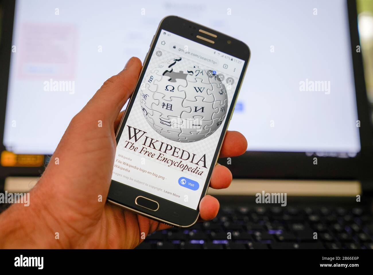 Bordeaux , Aquitaine / France - 10 11 2019 : Hands holding smartphone displaying logo of Wikipedia website homepage on a screen Stock Photo