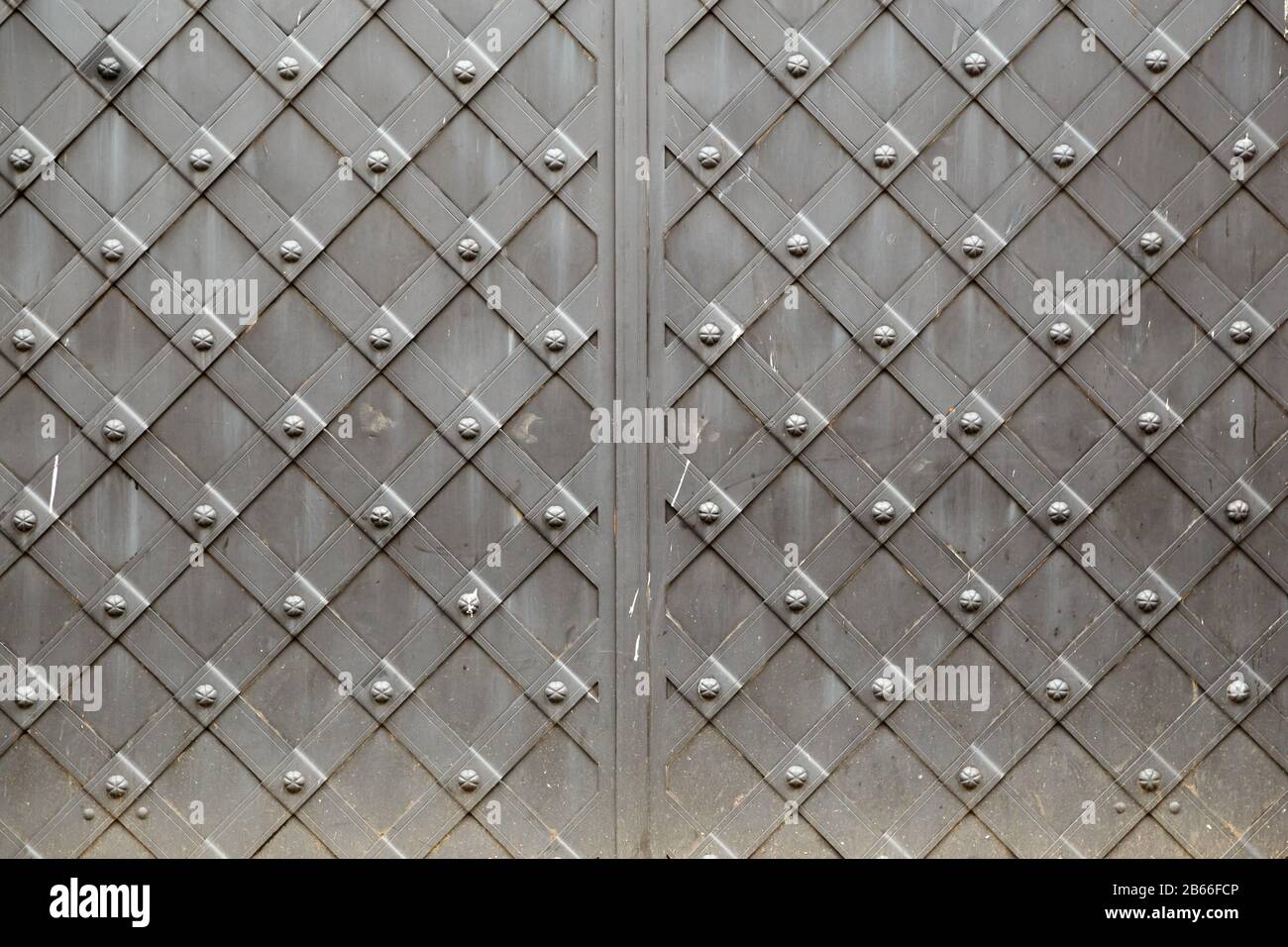 Old vintage metal panel with decorative ornamental cellular pattern