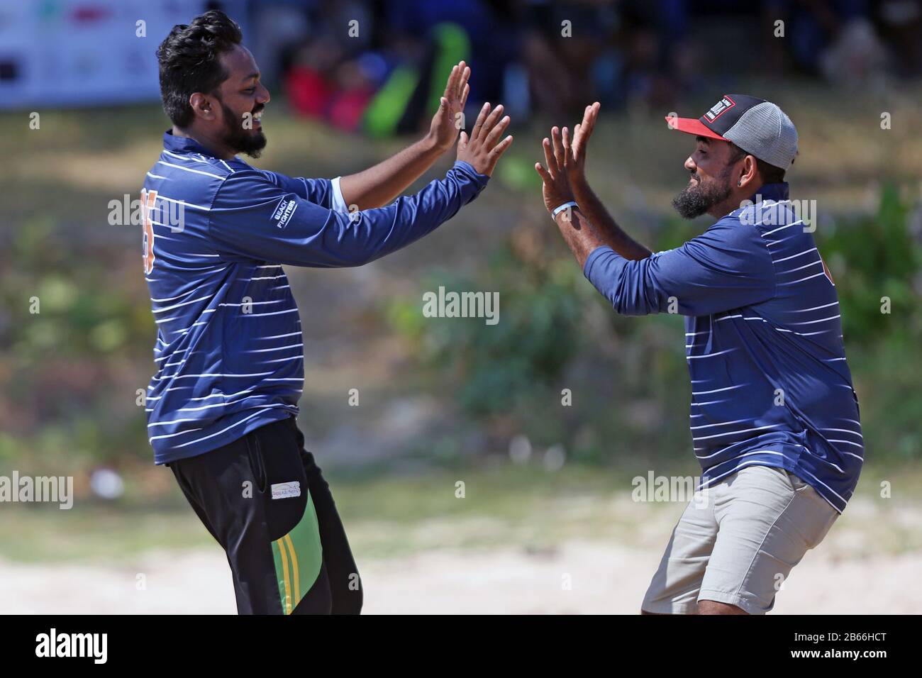 Sri Lankan cricket fans play a game of cricket on the beach at Galle ...