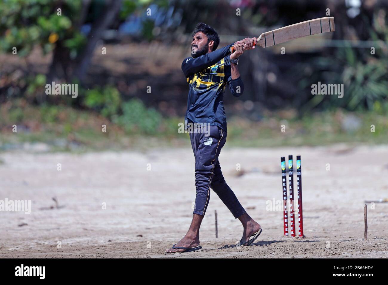 Sri Lankan cricket fans play a game of cricket on the beach at Galle ...